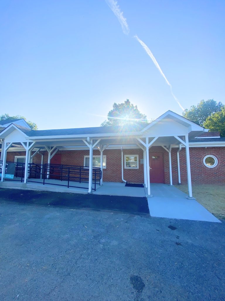 Brick building with new covered walkway and accessible ramp