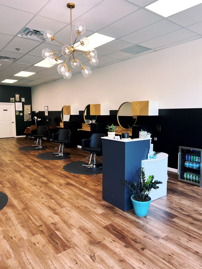 Salon styling stations with mirrors and sputnik chandelier