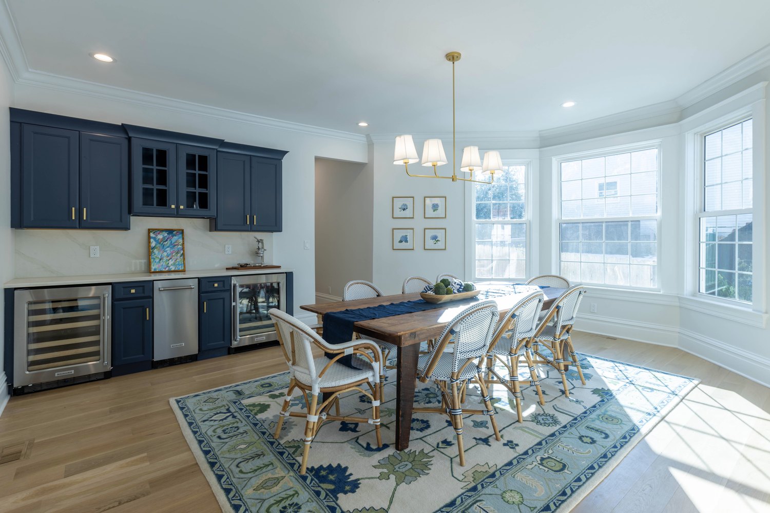Custom home dining area with navy cabinetry and a bay window