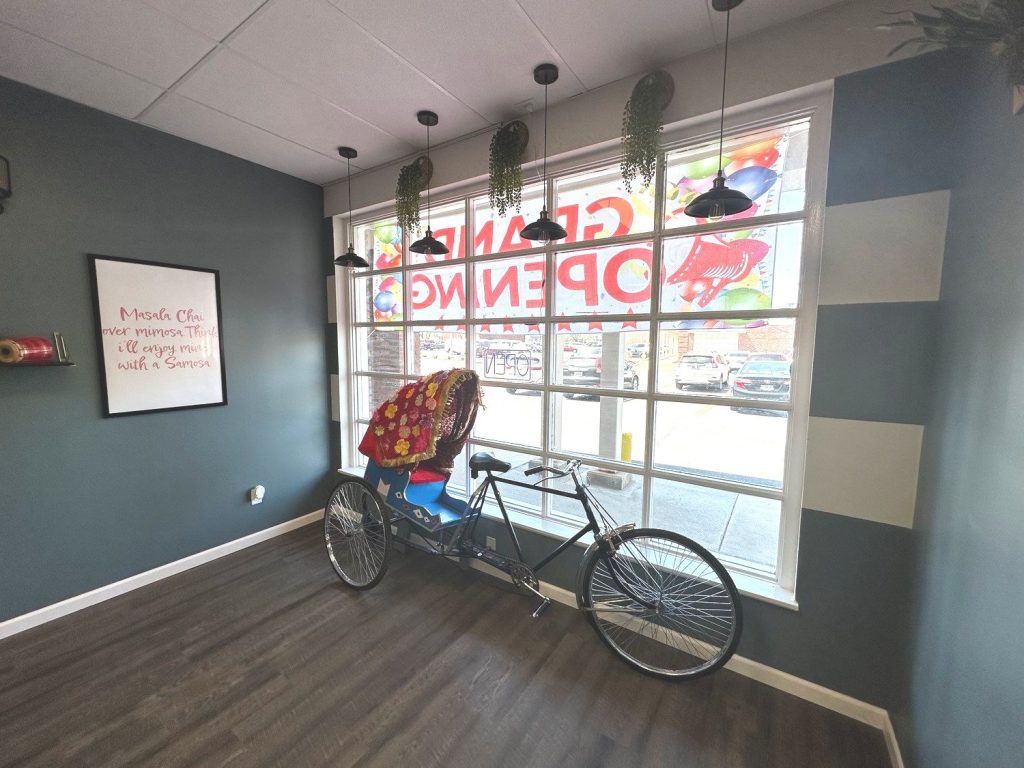Restaurant dining area with bicycle and window signage