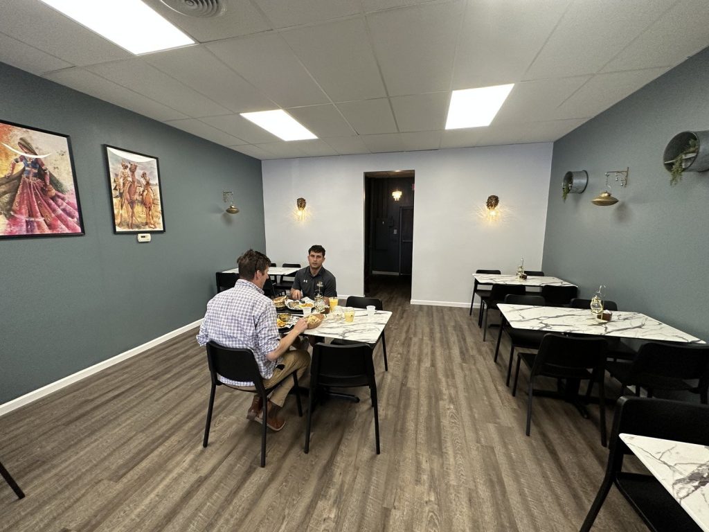 Diners at a table in the finished restaurant