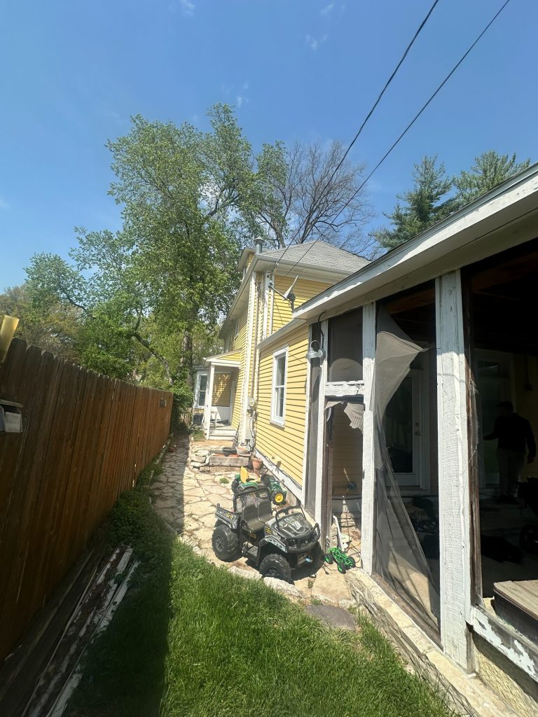 Side yard between the original house and the property fence