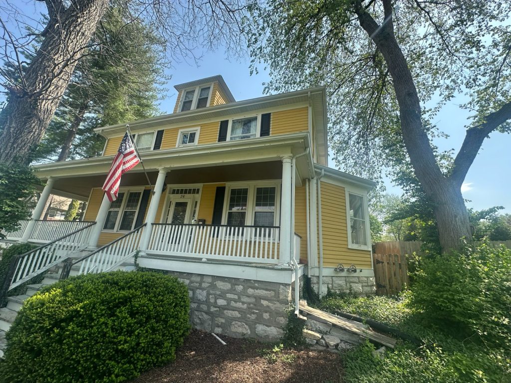 Front elevation of the original hundred-year-old house with its stone foundation