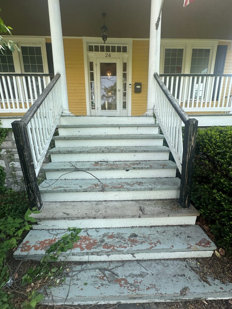 Worn original front steps leading up to the entry