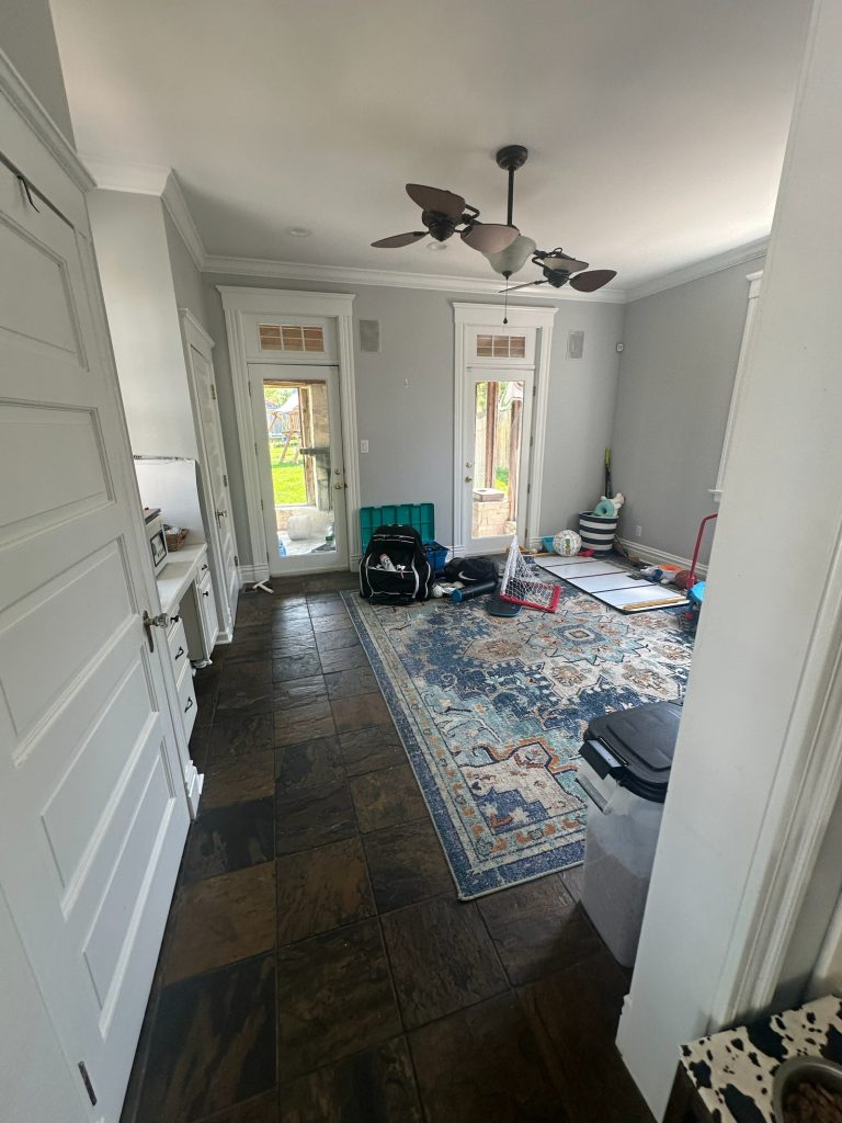 Original living space with a ceiling fan and dark flooring