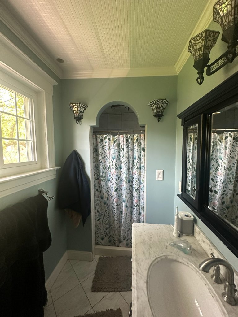 Original bathroom with an arched alcove and dark trim