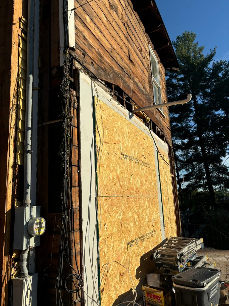 Plywood patch where an original window opening was closed up