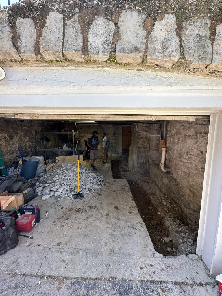 Trench opened alongside the original stone foundation for underpinning