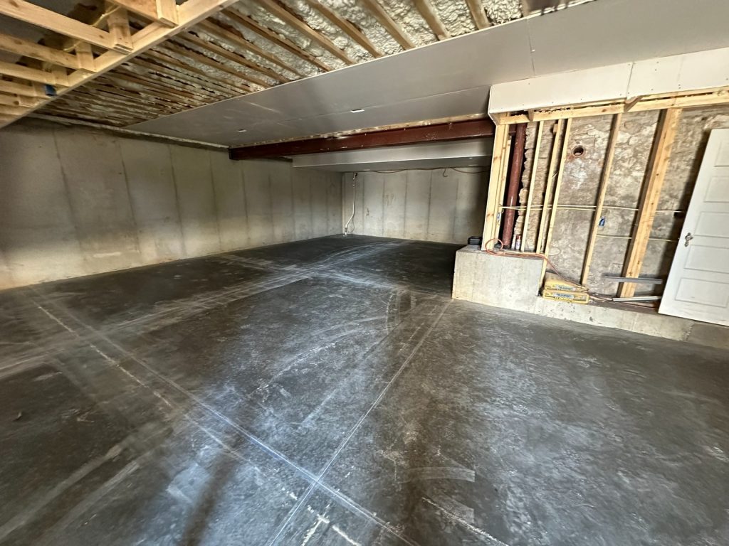 Finished lower level slab with the new steel beam in place