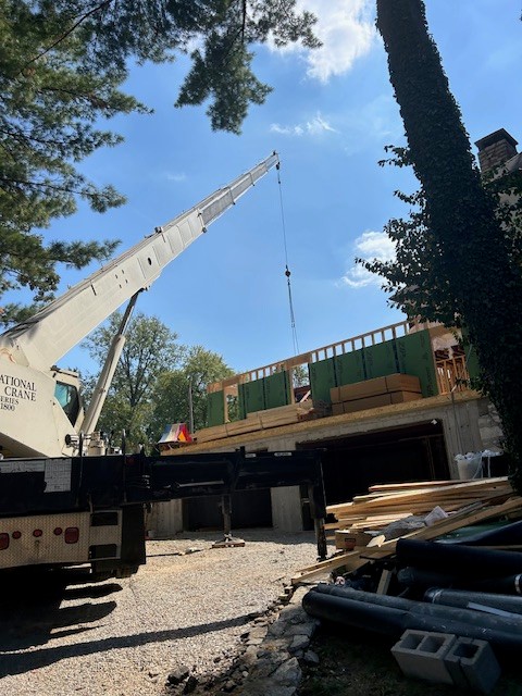 Crane lifting steel beams into place on site