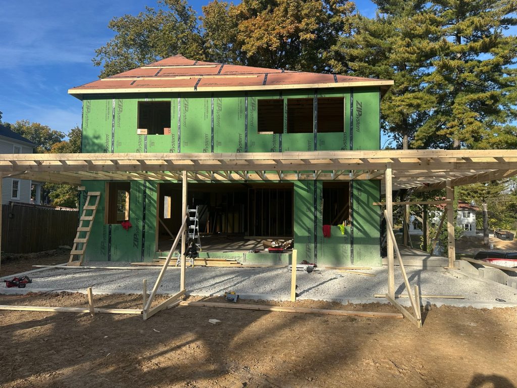Front of the original house supported on temporary posts during leveling