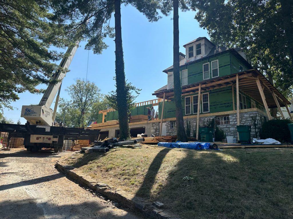 Crane on site as the new addition is framed alongside the wrapped original house