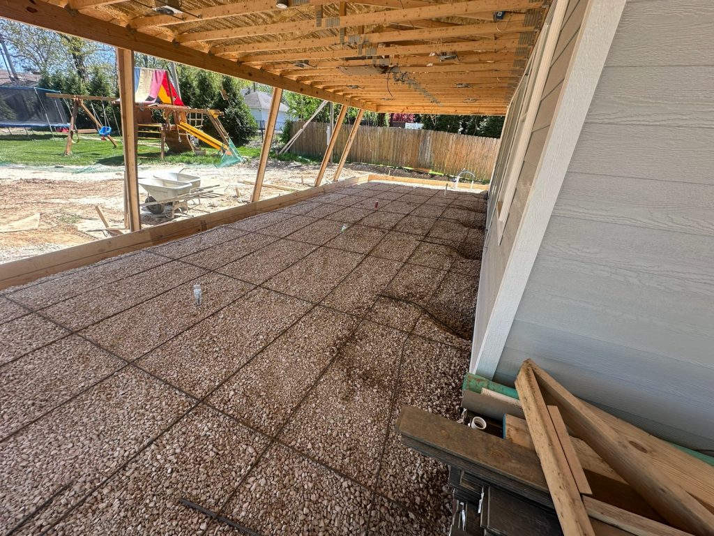 Gravel base and slab beneath the new porch framing