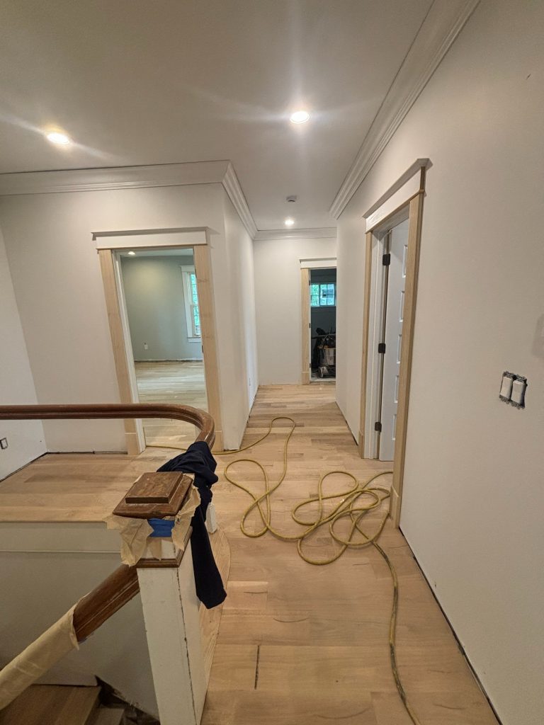 Hallway after drywall, with the new stair opening framed