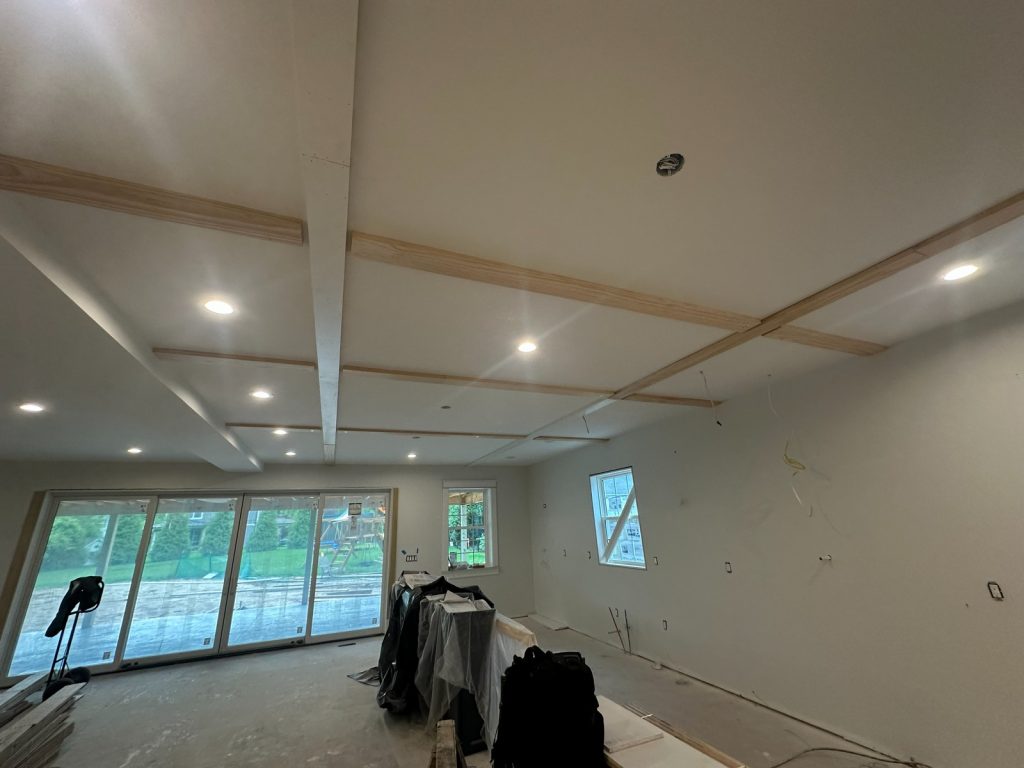 Great room with the coffered ceiling drywalled and sliding doors fitted