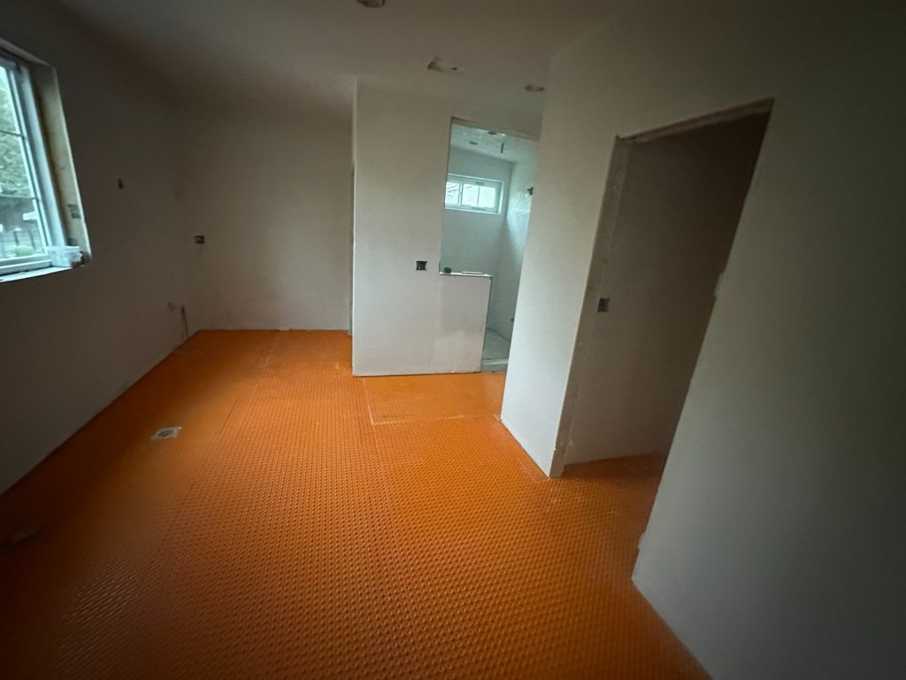 Uncoupling membrane laid ready for floor tiling
