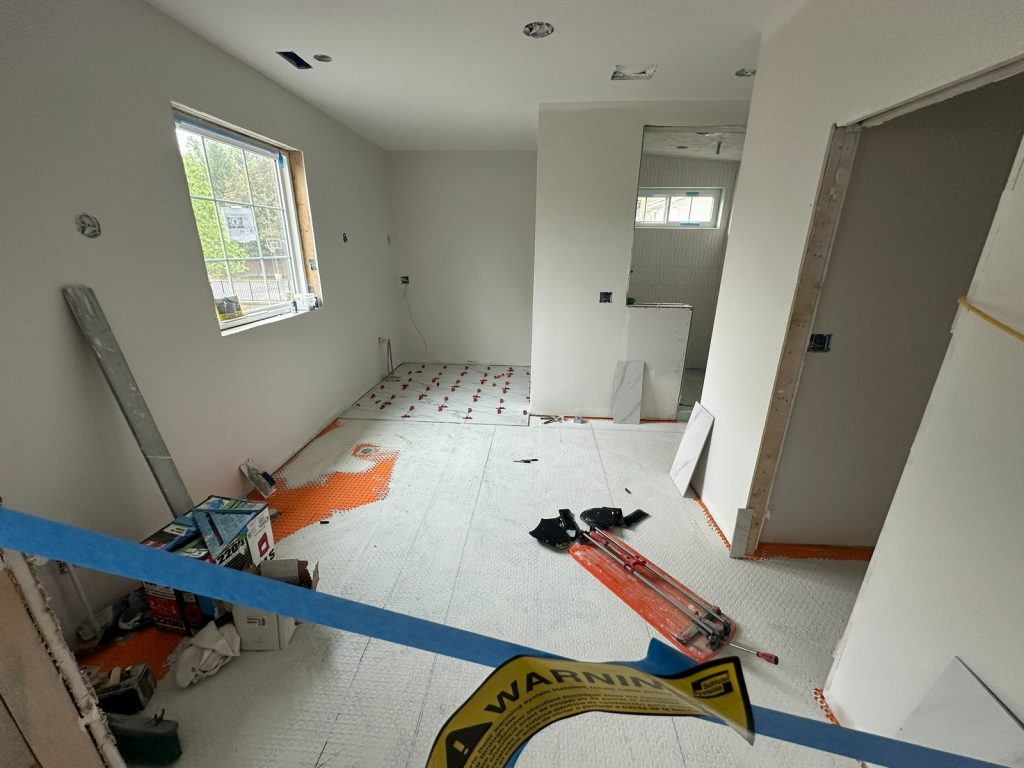 Tiling underway across the bathroom floor