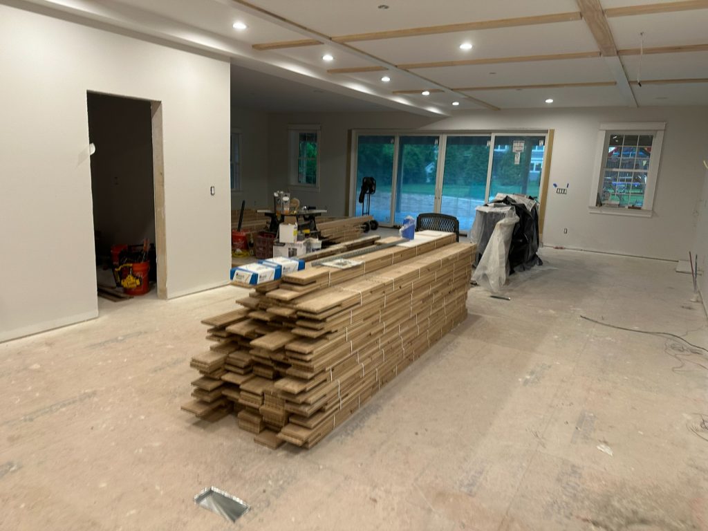 Kitchen and great room with hardwood flooring stacked to acclimate