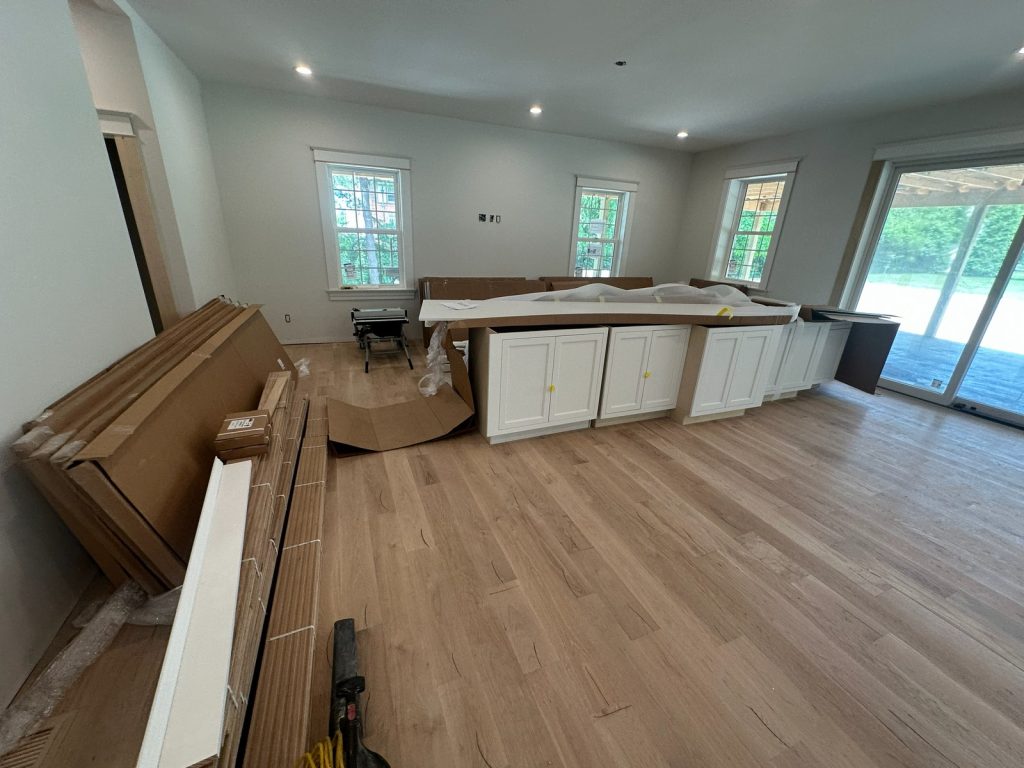 Kitchen island cabinetry set on the new hardwood floor