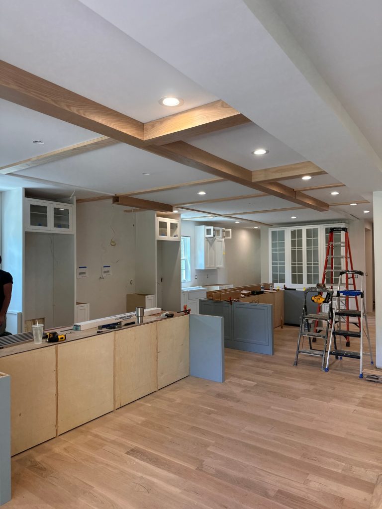 Kitchen cabinetry installed beneath the new beamed ceiling