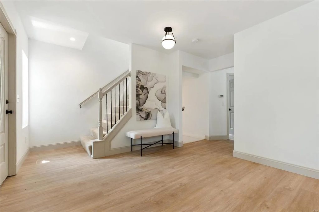 Entry hall with staircase and framed artwork