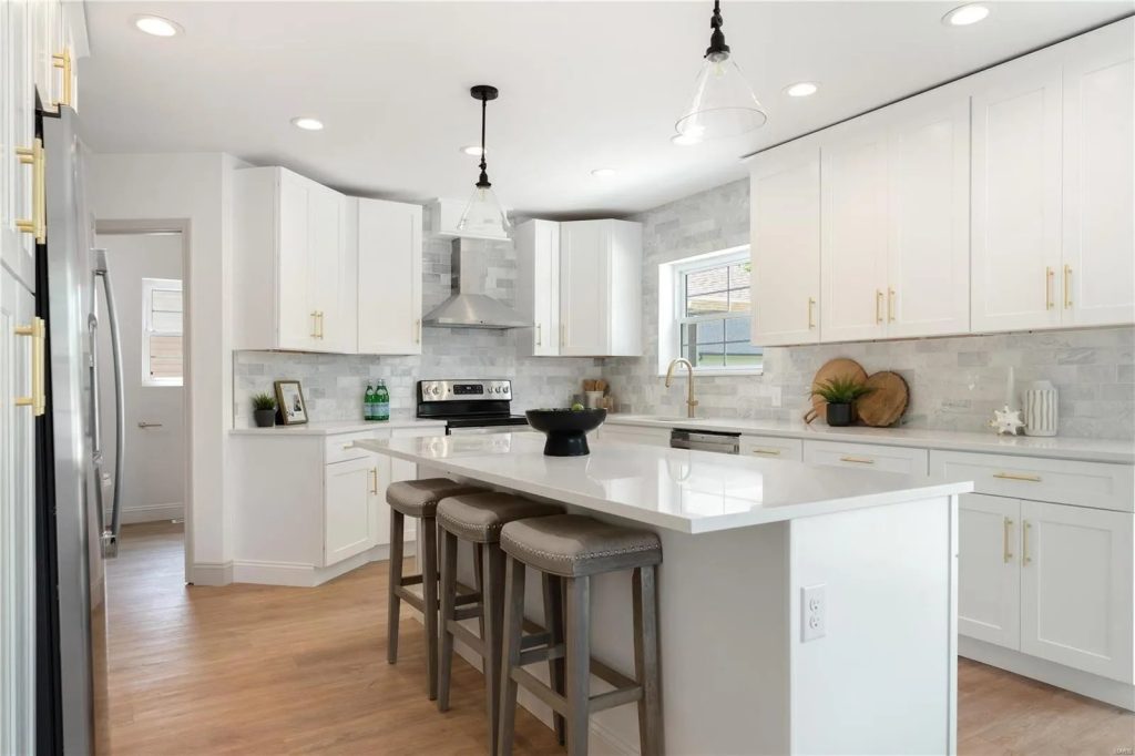 Kitchen island with three stools and pendant lights