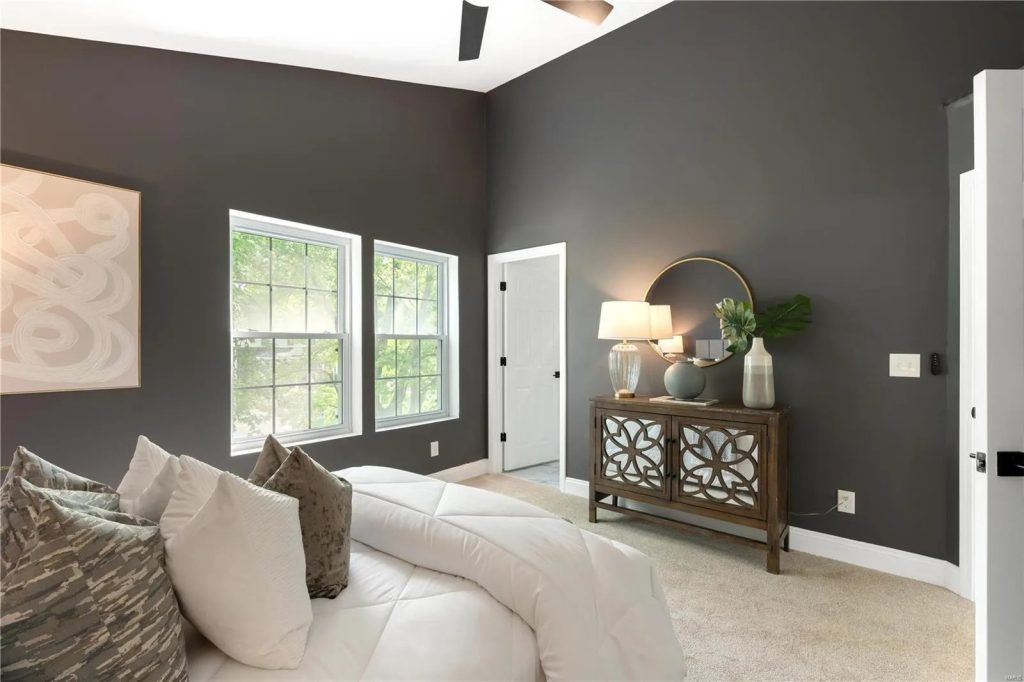 Bedroom with dark accent wall and wood console