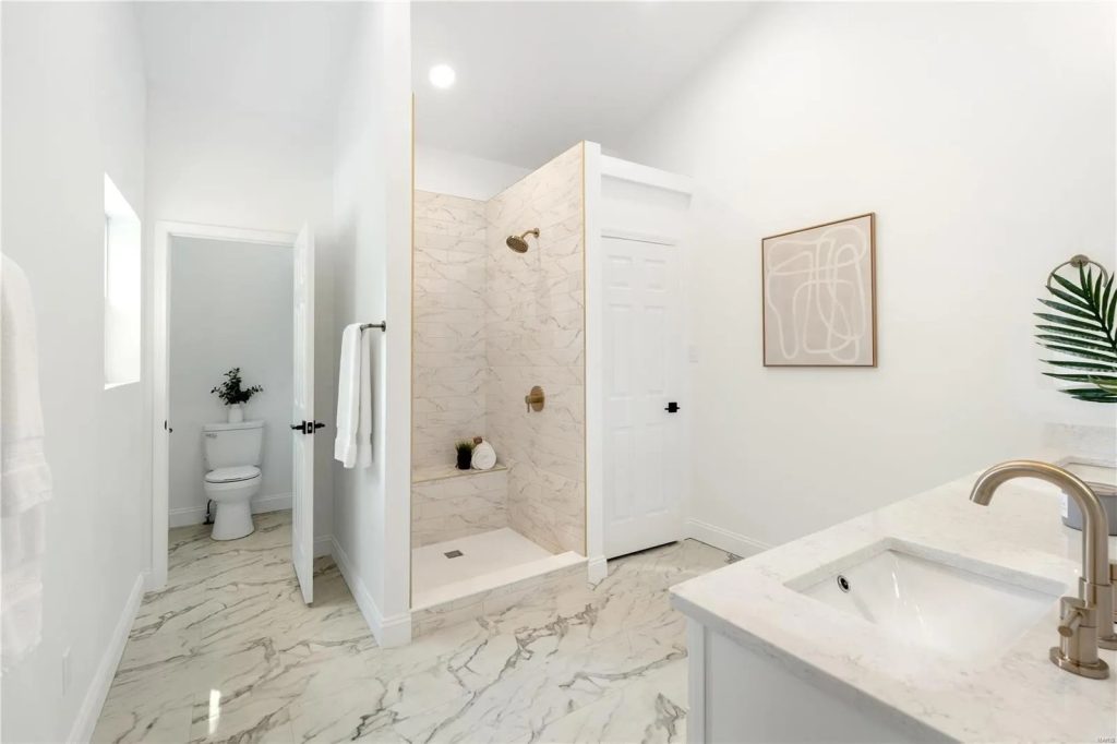 Bathroom with marble tile shower and vanity