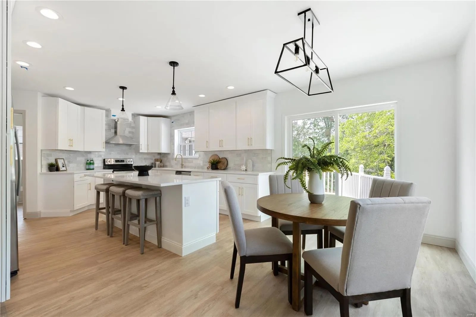 Kitchen and dining area with round table and island