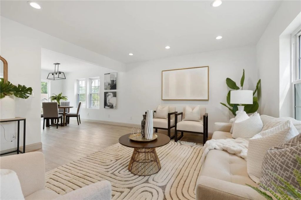 Living room with sofa, rug and dining area beyond