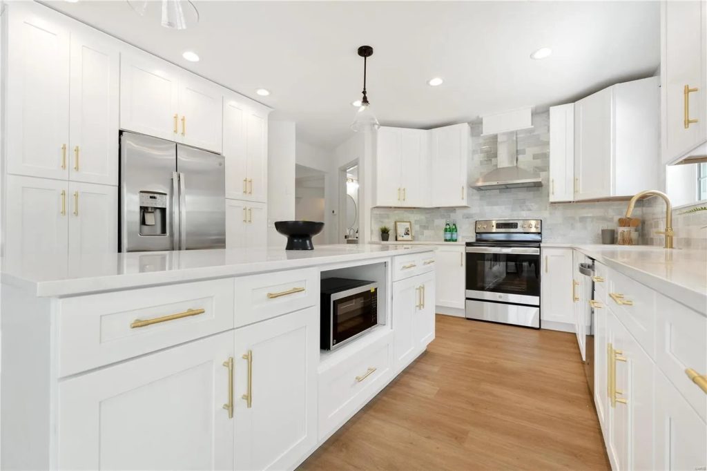 Kitchen with stainless appliances, island and gold hardware