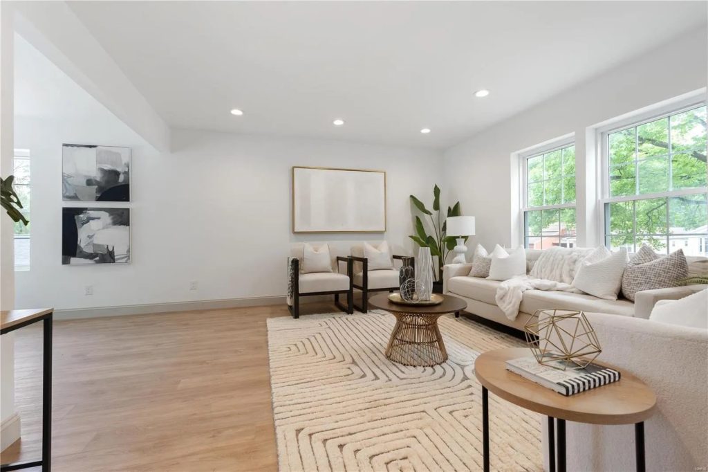 Living room with sofas and three windows
