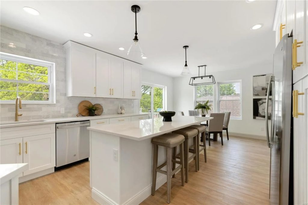 Kitchen with island seating and dining area beyond