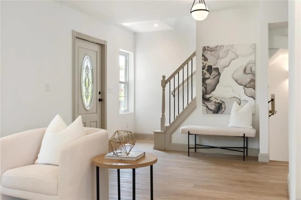 Entry hall with bench, staircase and front door