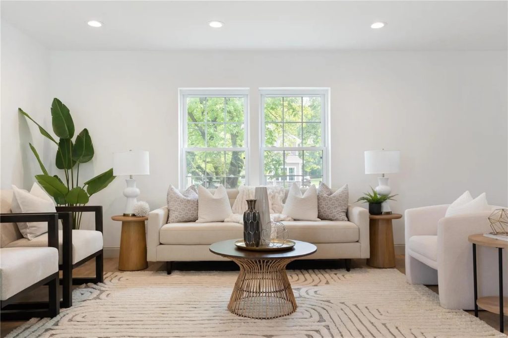Living room with cream sofas and armchairs