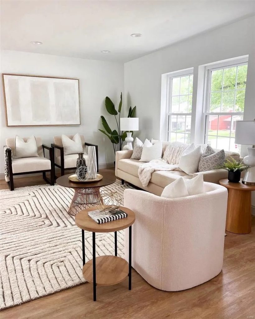Living room with armchairs, sofa and round tables