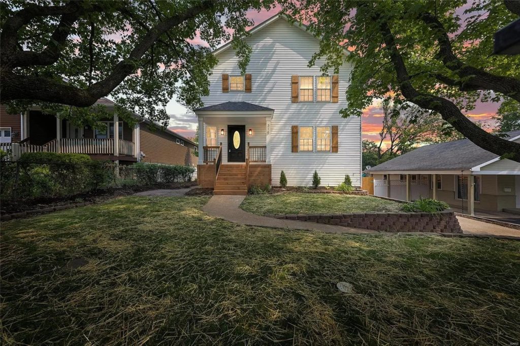 House exterior at dusk with lit windows