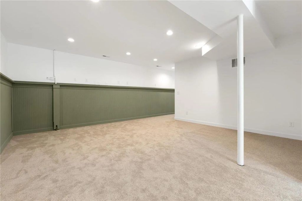 Finished lower level with green wainscot panelling