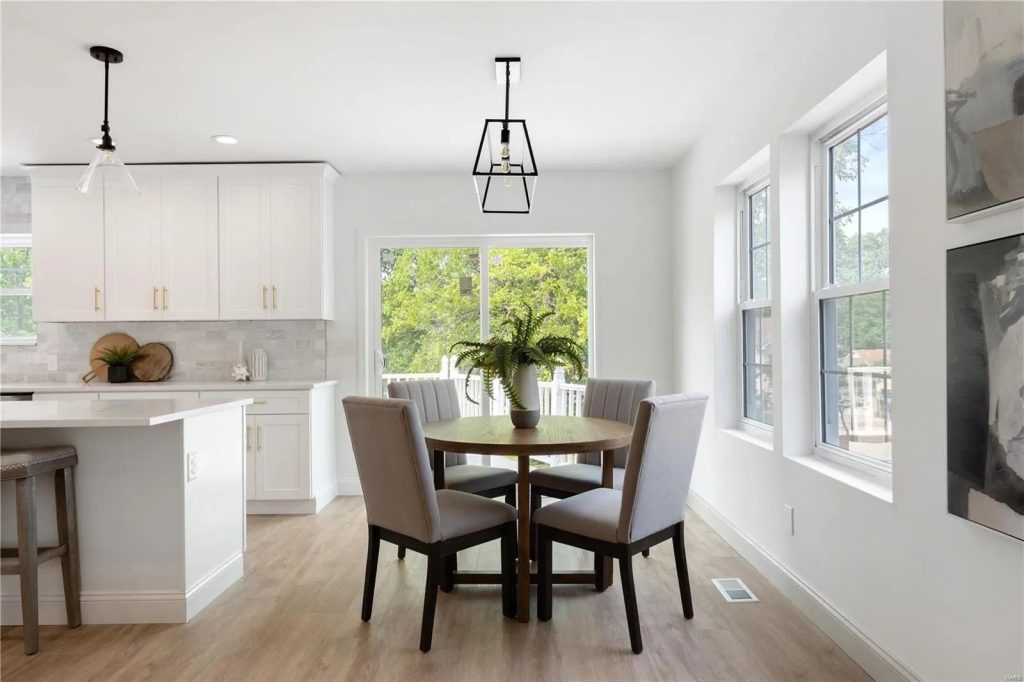 Kitchen and dining area with round table and windows