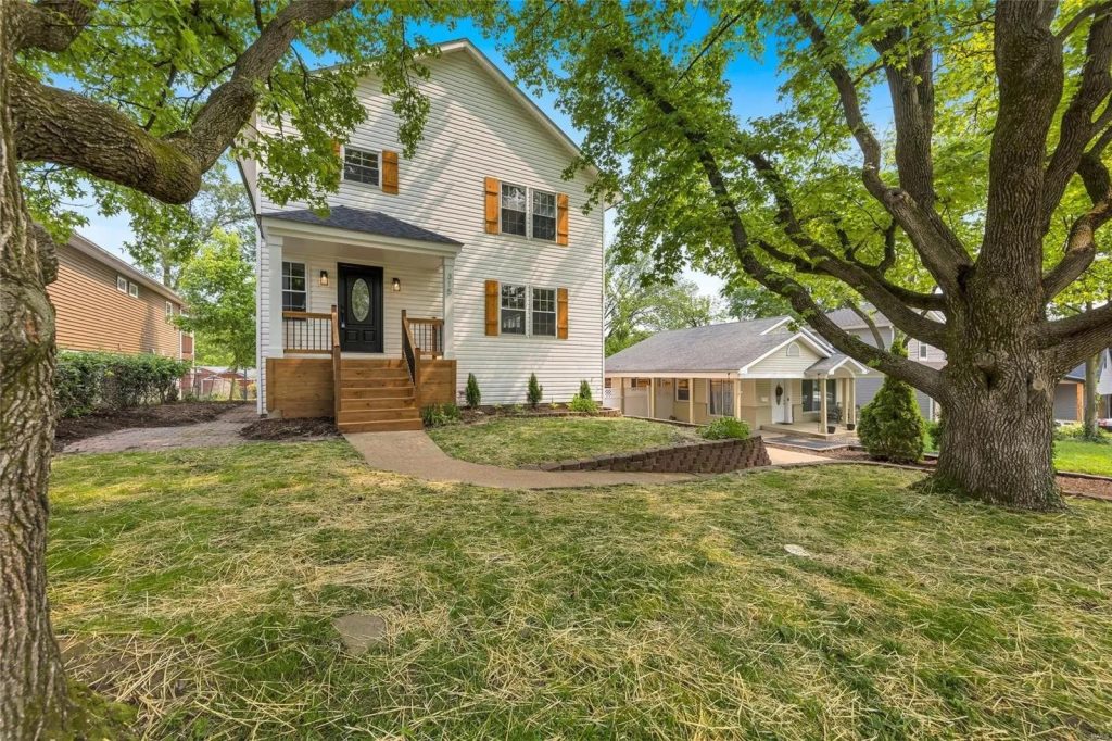 House exterior under mature oak trees