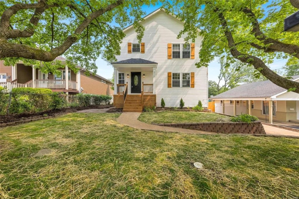 House and front yard under mature oak trees