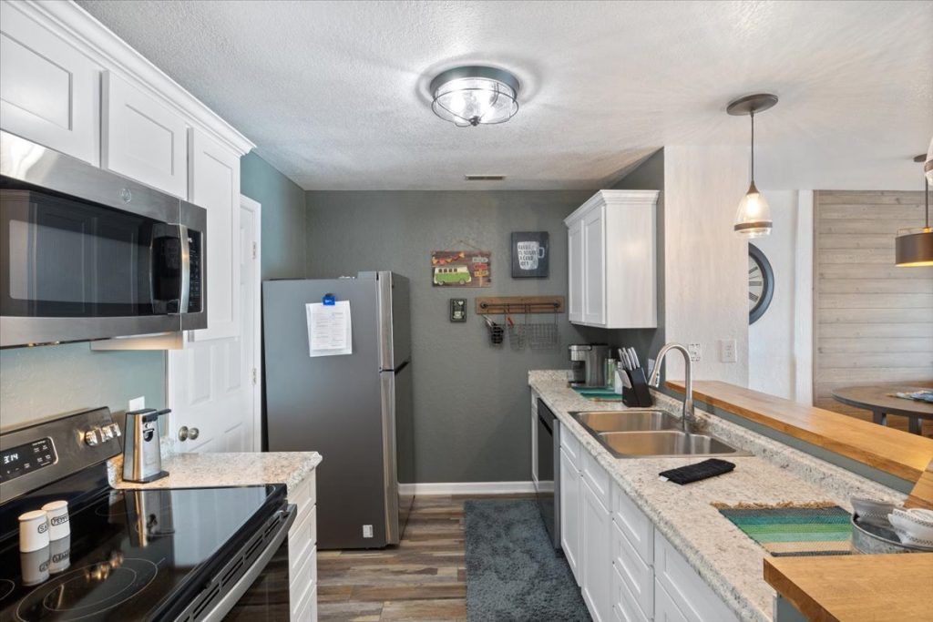 Kitchen with stainless appliances and butcher block countertop