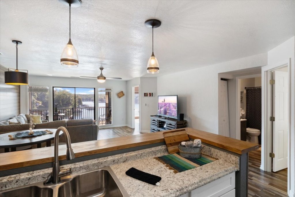 Kitchen sink and countertop with living room beyond