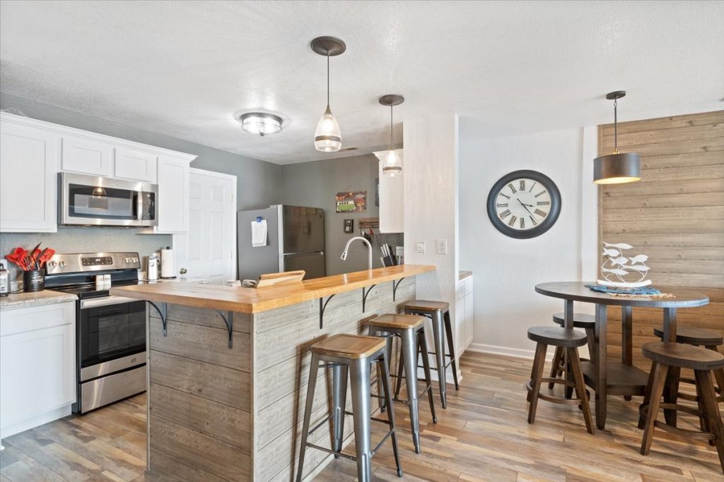 Kitchen with breakfast bar stools and dining table