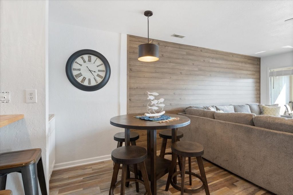 Dining table and stools beside the shiplap accent wall