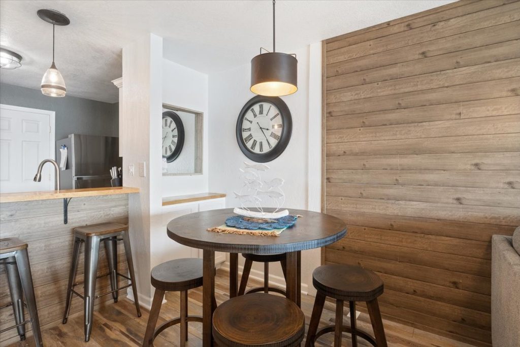Dining area with round table and wood accent wall