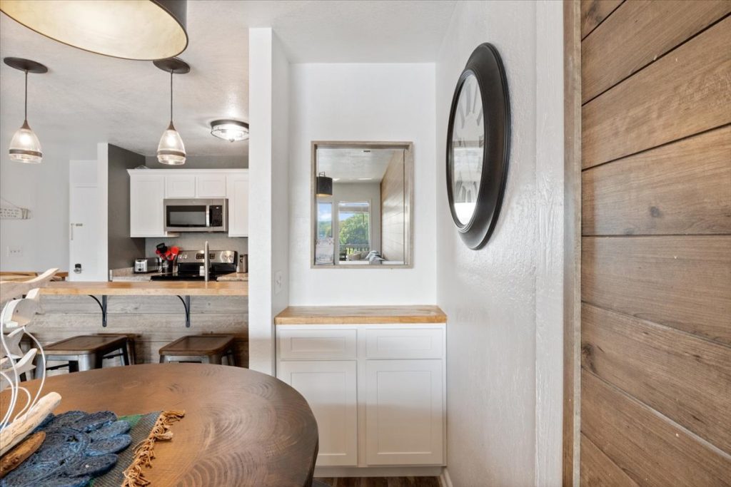Dining table with mirror and wood accent wall