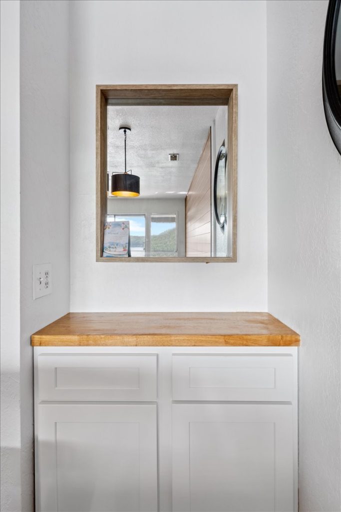 Cabinet with butcher block top and framed mirror