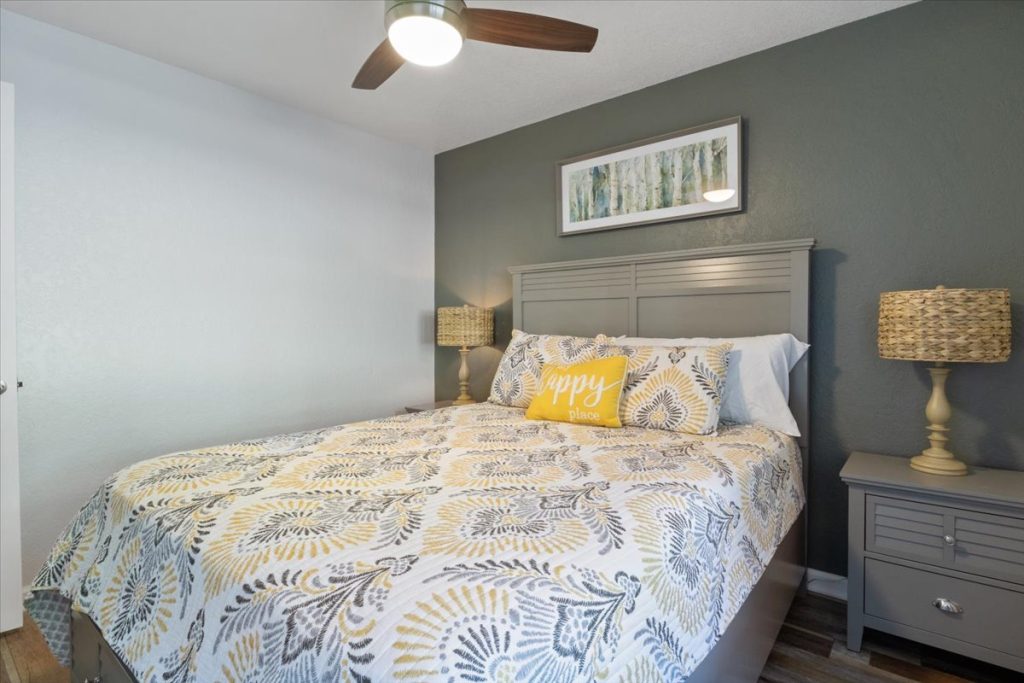 Bedroom with patterned bedding and bedside lamps