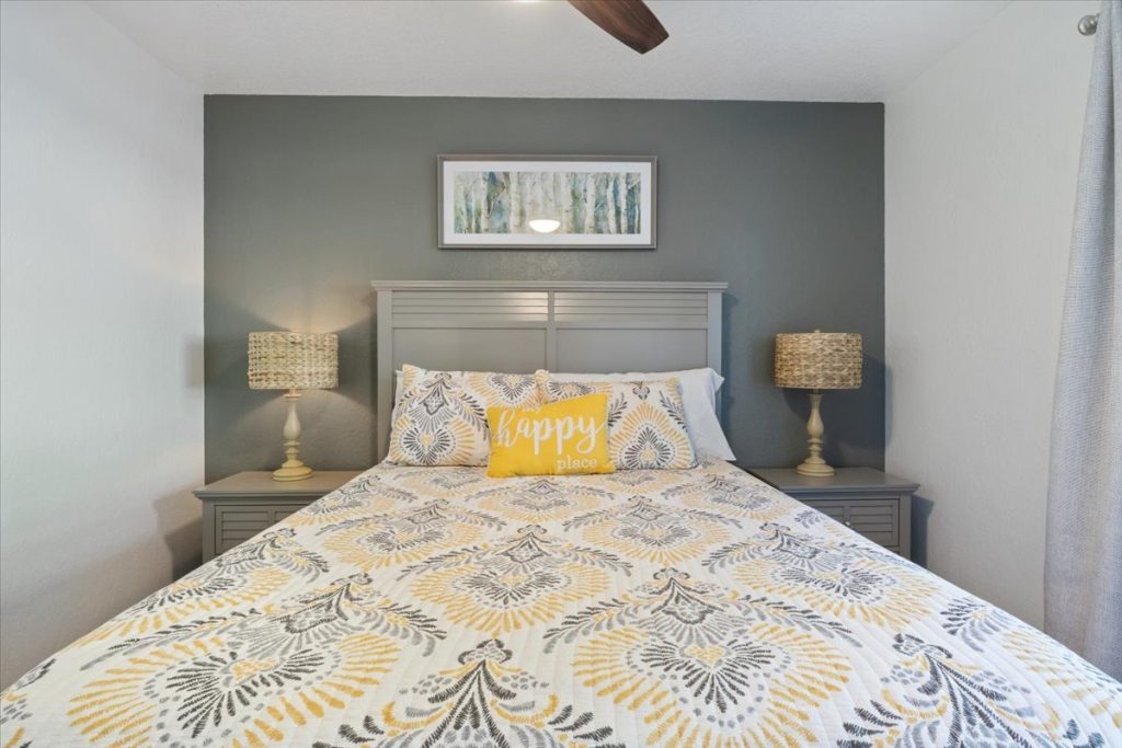 Bedroom with gray headboard and two bedside lamps